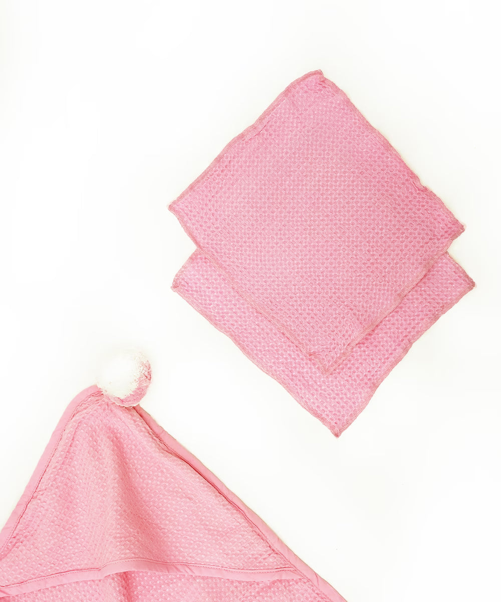 Pink textured baby hooded baby towel on a white background