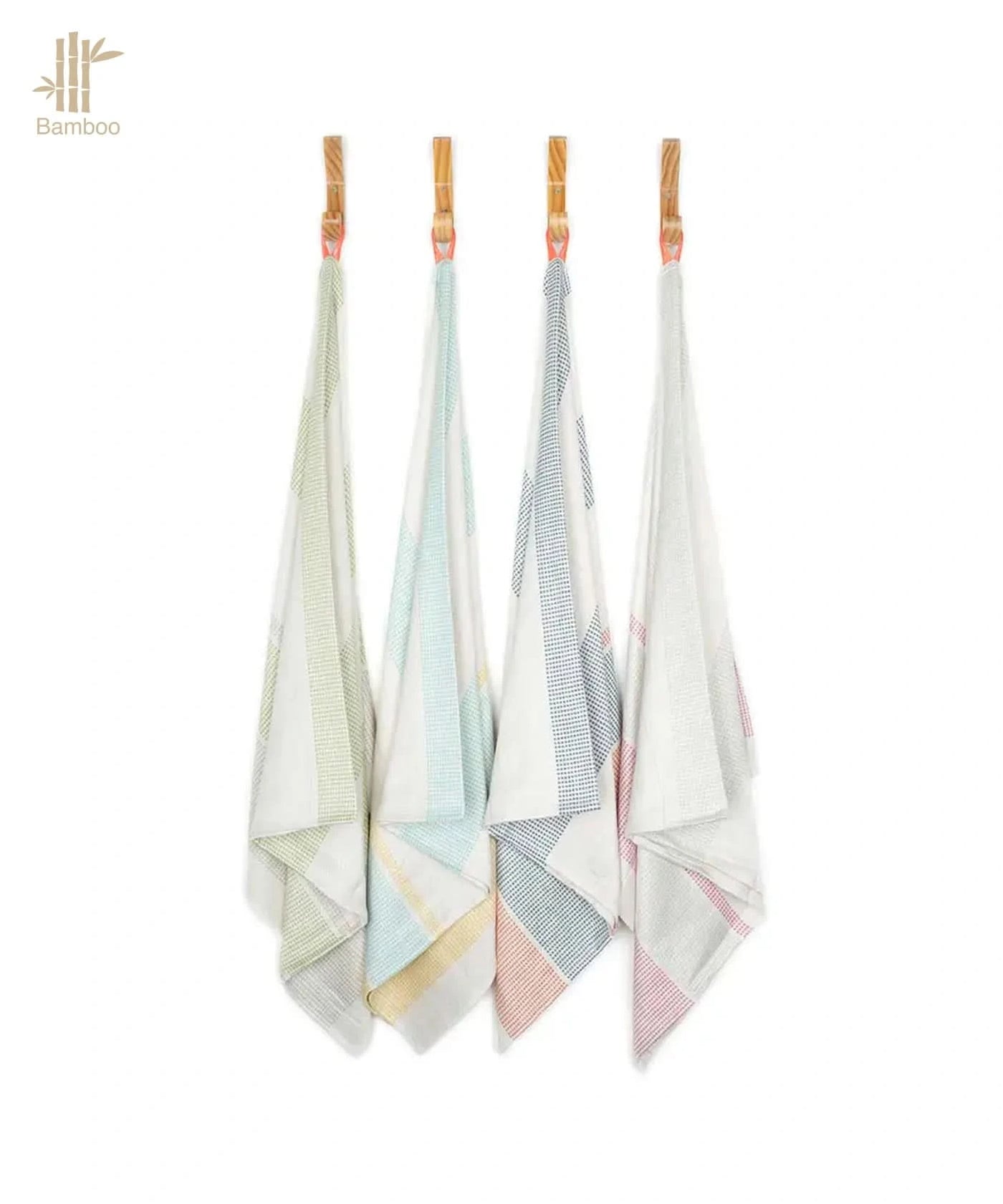 Four bamboo towels hanging on a rack with a white background