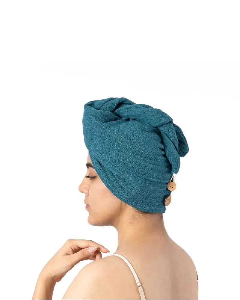 Woman wearing a Banana double cloth hair towel - dutch teal on a white background