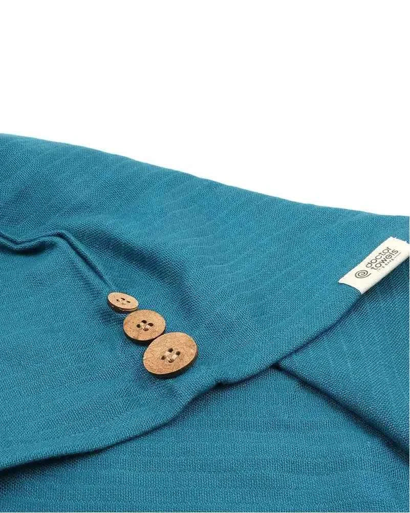 Close-up of a Banana double cloth hair towel with wooden buttons and a brand label on a towel.