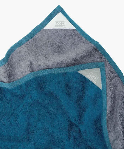 Blue and gray towel with brand labels on a white background