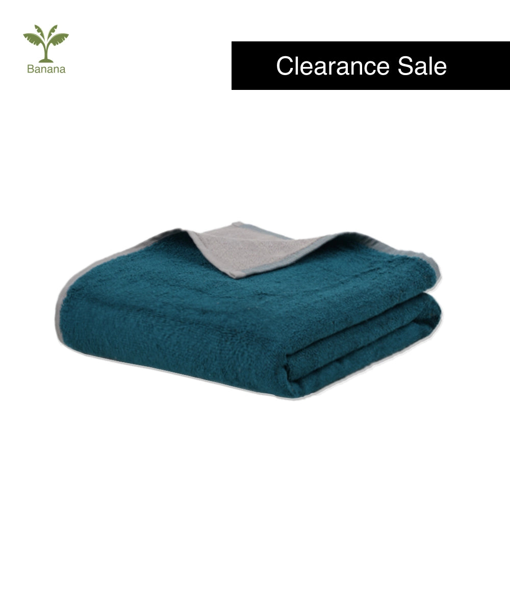 Folded teal blanket with gray lining on a white background, featuring 'Clearance Sale' text.