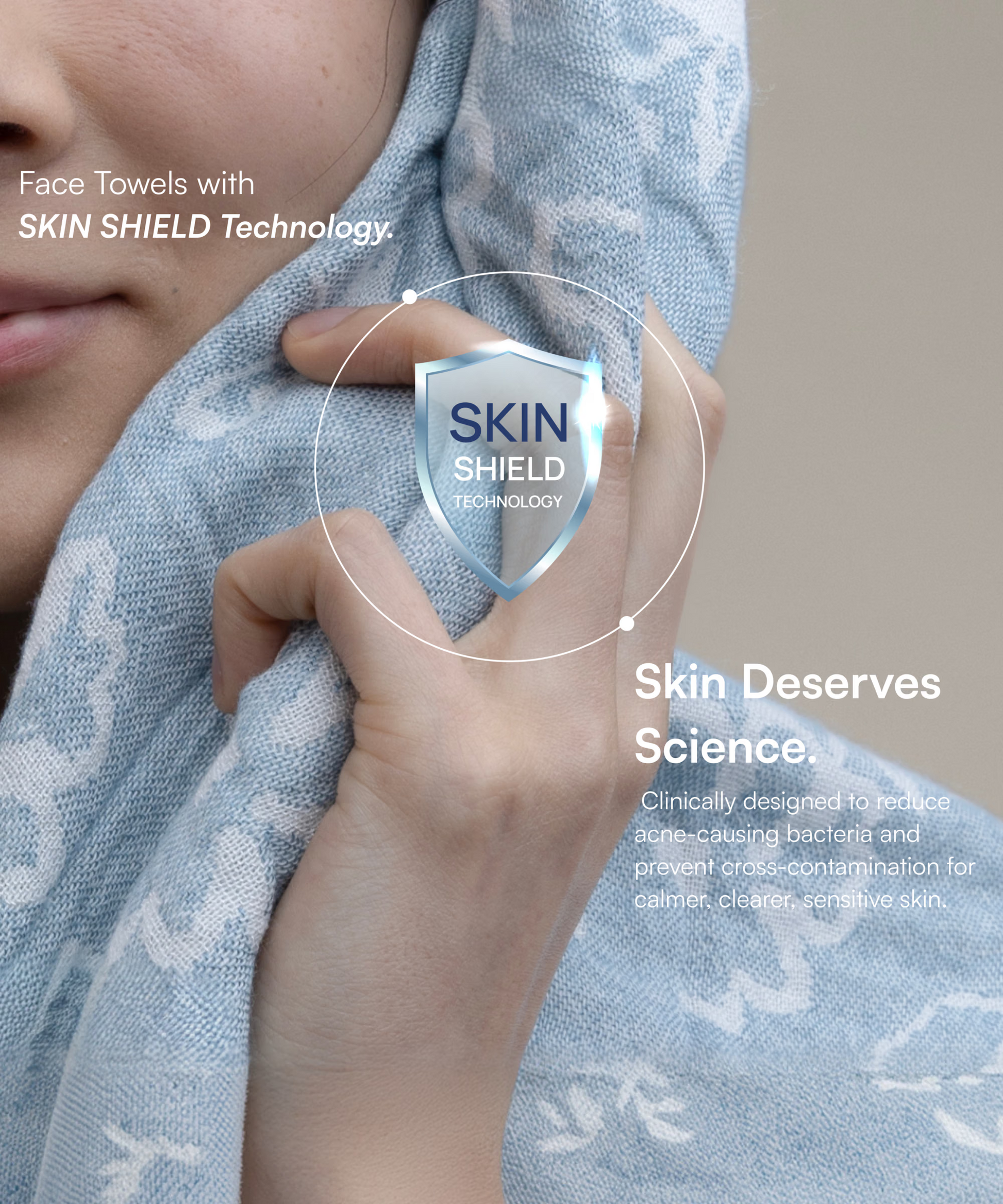 Woman holding a blue patterned Doctor Towels face towel with Skin Shield Technology against her cheek.