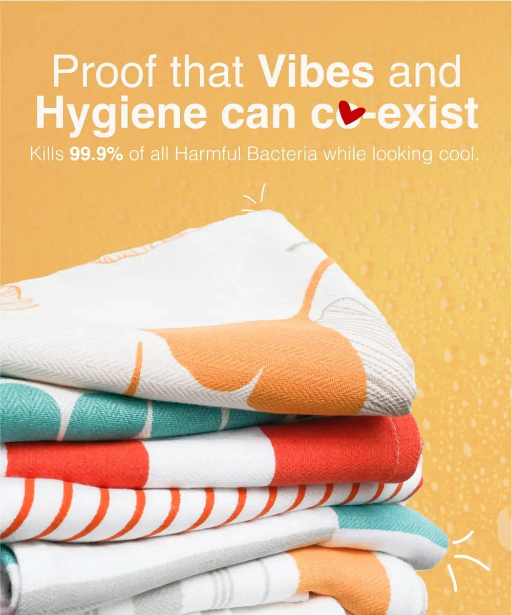 Stack of colorful towels with text about hygiene and bacteria-killing properties on a yellow background