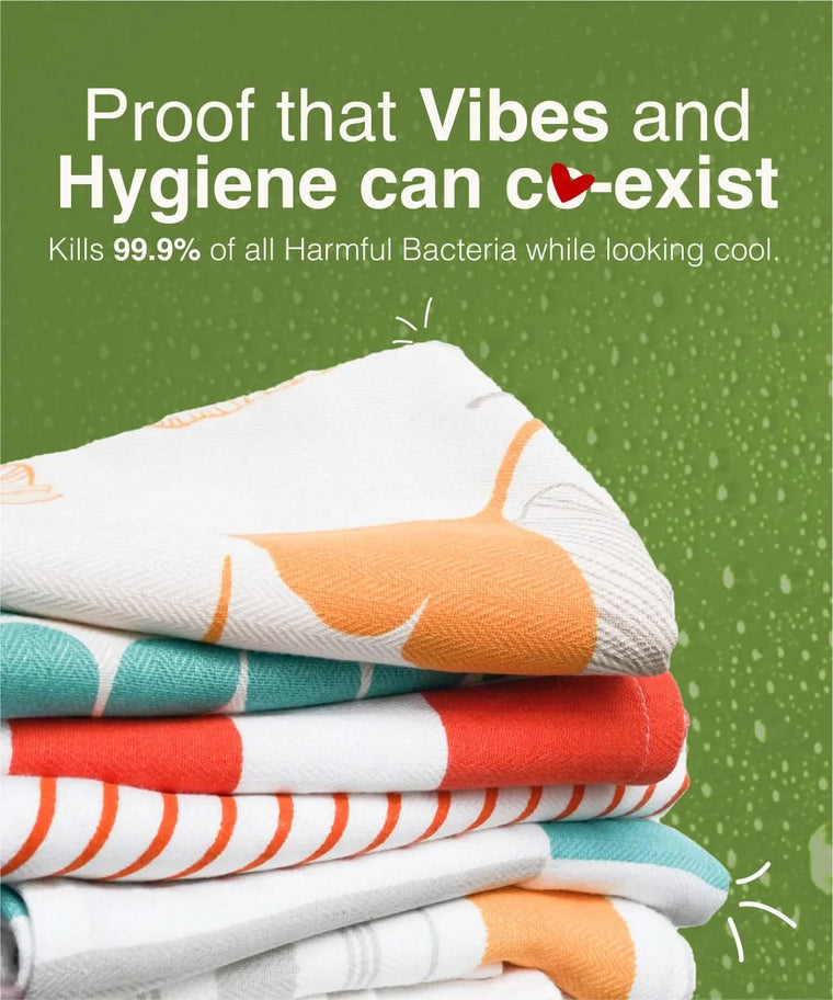 Stack of colorful towels with text about hygiene and bacteria-killing properties on a green background