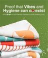 Stack of colorful towels with text about hygiene and bacteria-killing properties on a green background