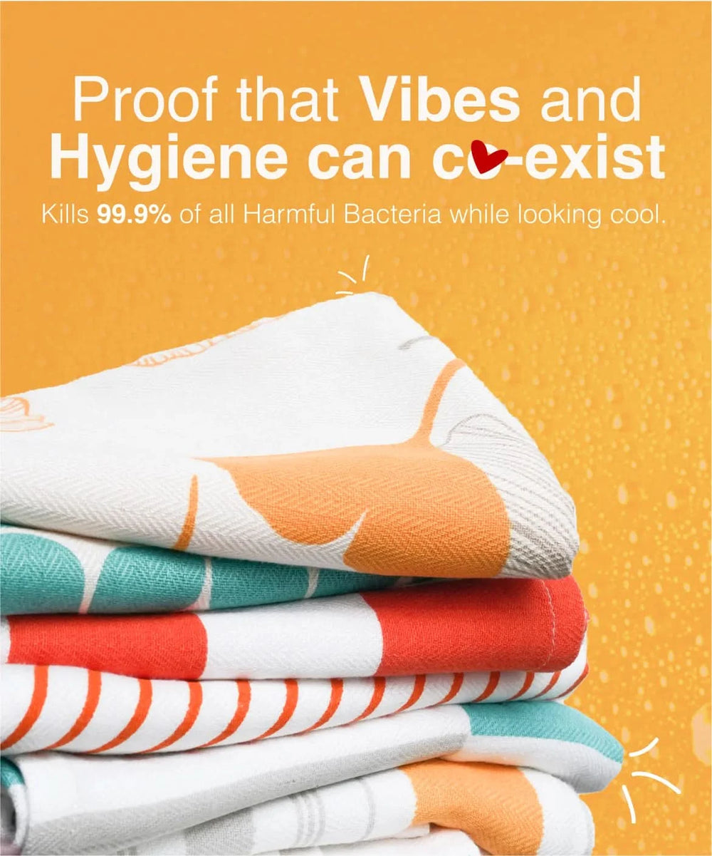 Stack of colorful towels with text about hygiene and bacteria killing on an orange background
