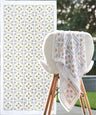 White towel with floral pattern on a wooden stand, next to a sheet of matching decorative stickers.