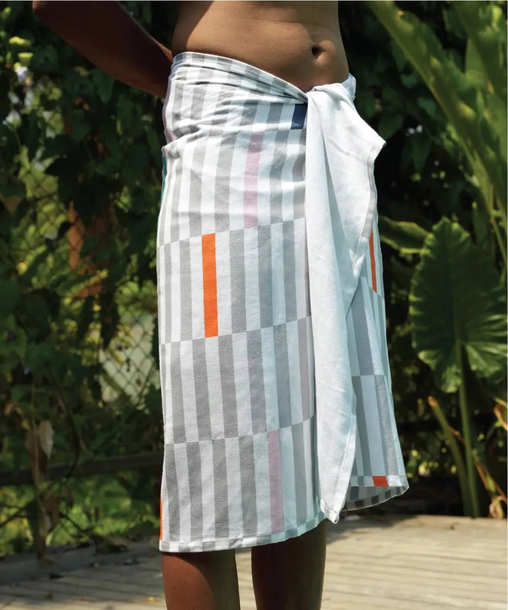 Person wearing a Piano Pop Bamboo Bath Towel around their waist with a natural background