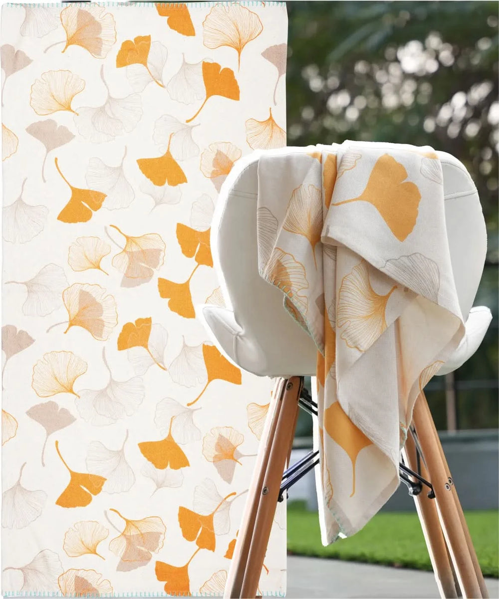 Towel with floral pattern draped over a chair outdoors