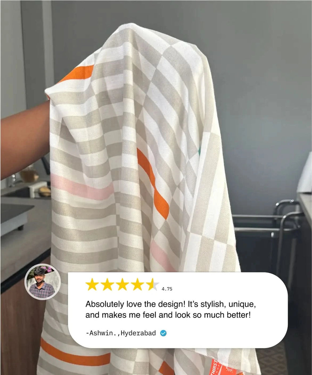 Person holding a patterned towel with a five-star rating and review on a gray background