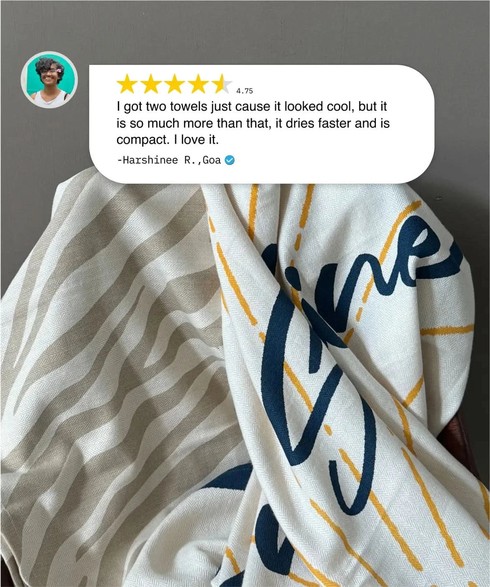 Two towels with different patterns and a customer review overlay on a gray background