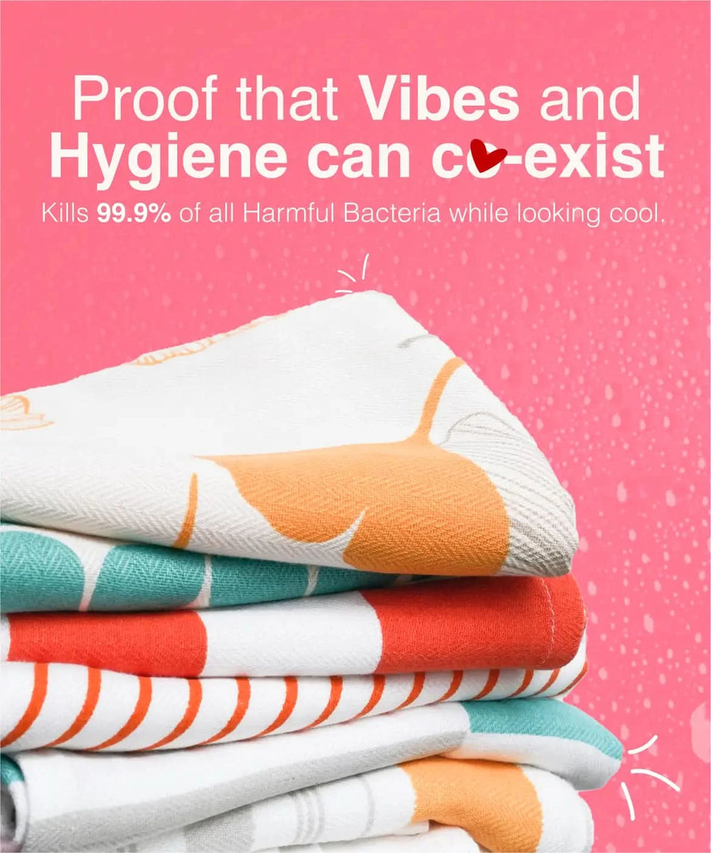 Colorful towels stacked on a pink background with text about hygiene and bacteria killing.