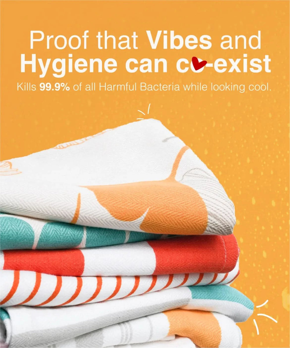 Stack of colorful folded towels on an orange background with text about hygiene and bacteria killing.
