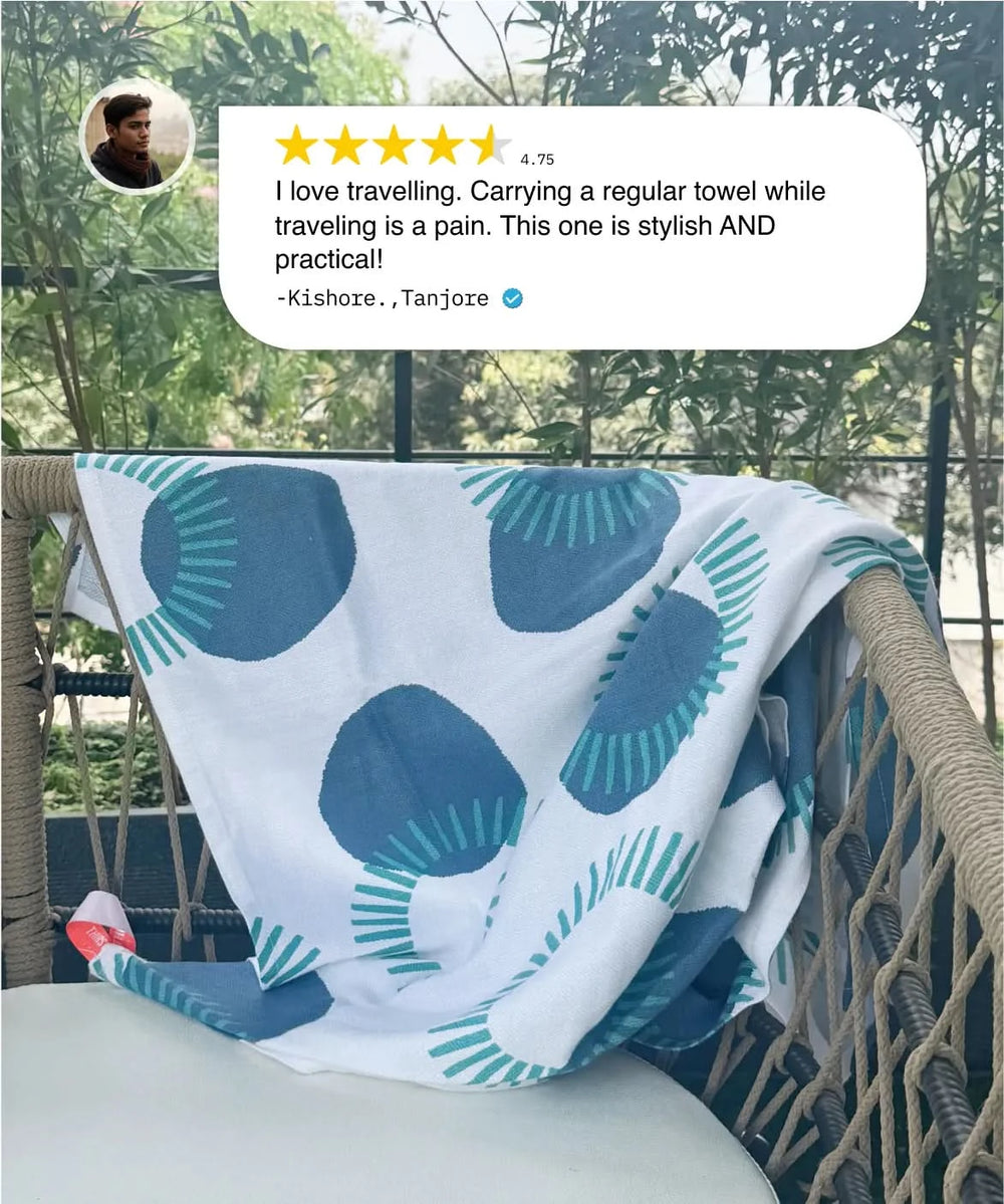 Blue and white patterned towel draped over a chair with a review above it.