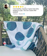 Blue and white patterned towel draped over a chair with a review above it.