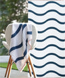 Navy and white striped towel draped over a chair with a blurred outdoor background