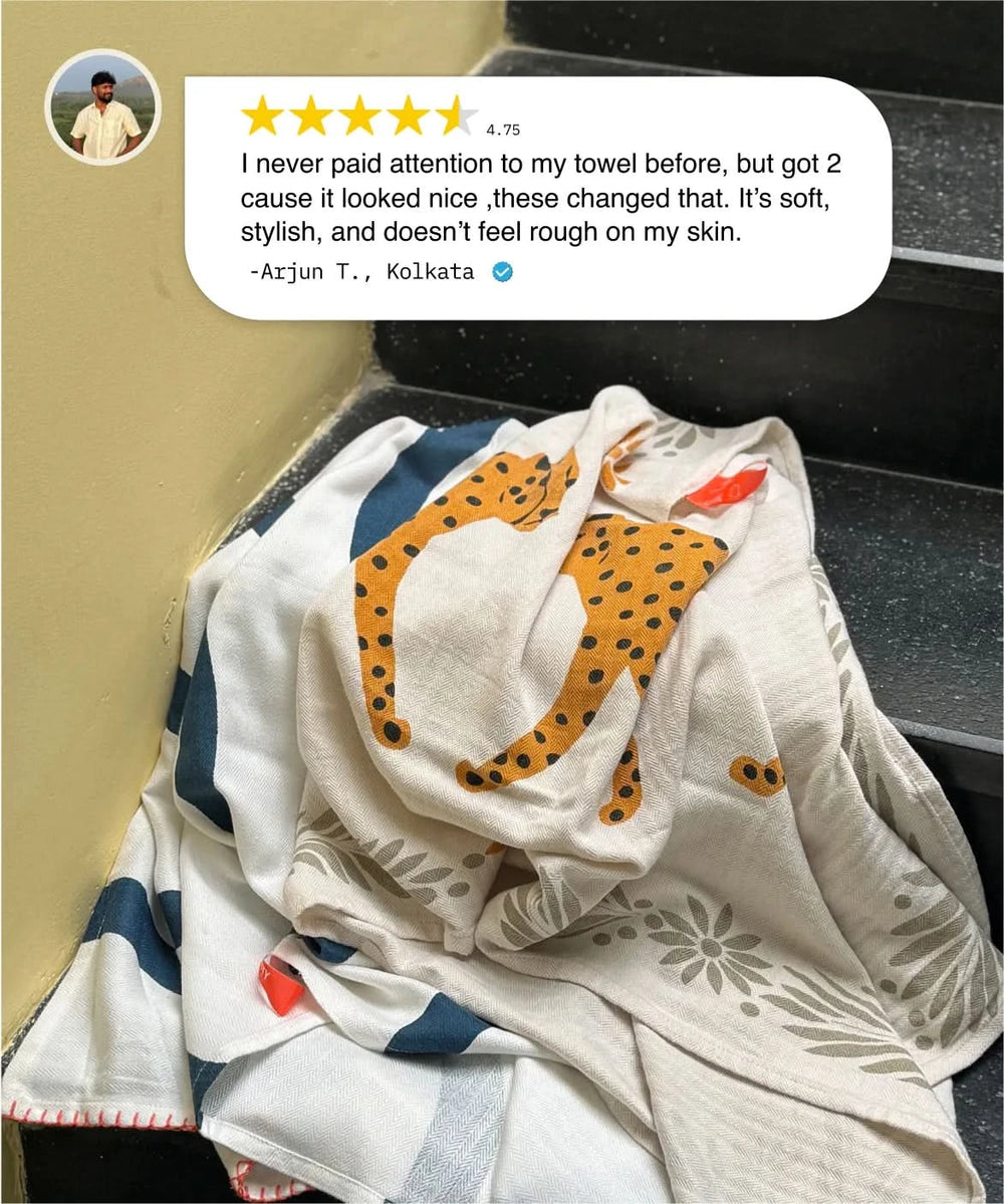 Folded towel with a leopard design and customer review on a car seat.