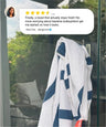 Blue and white striped towel hanging on a glass door with a five-star review above it.