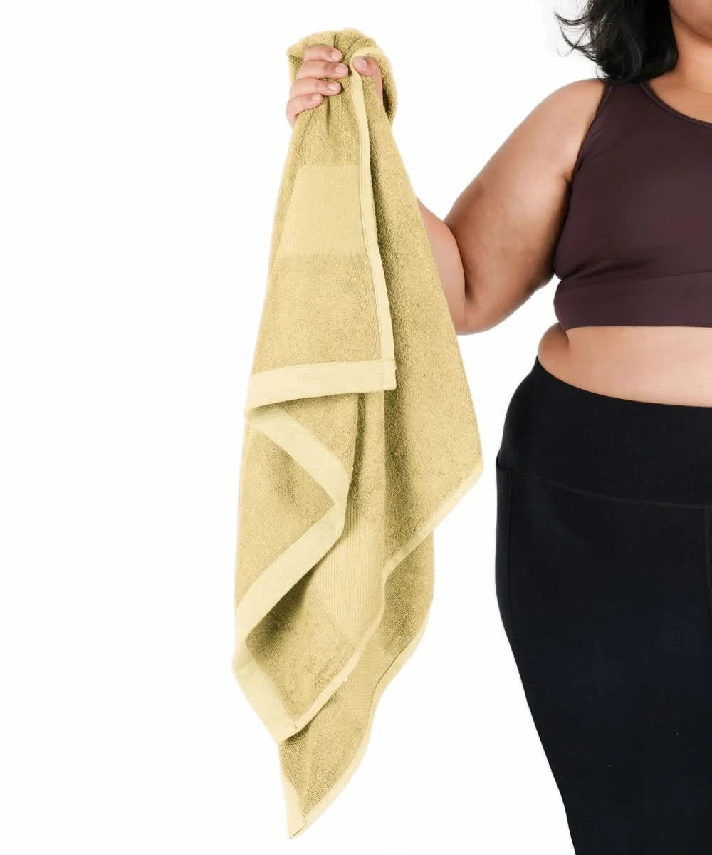Person holding a yellow towel with a white background