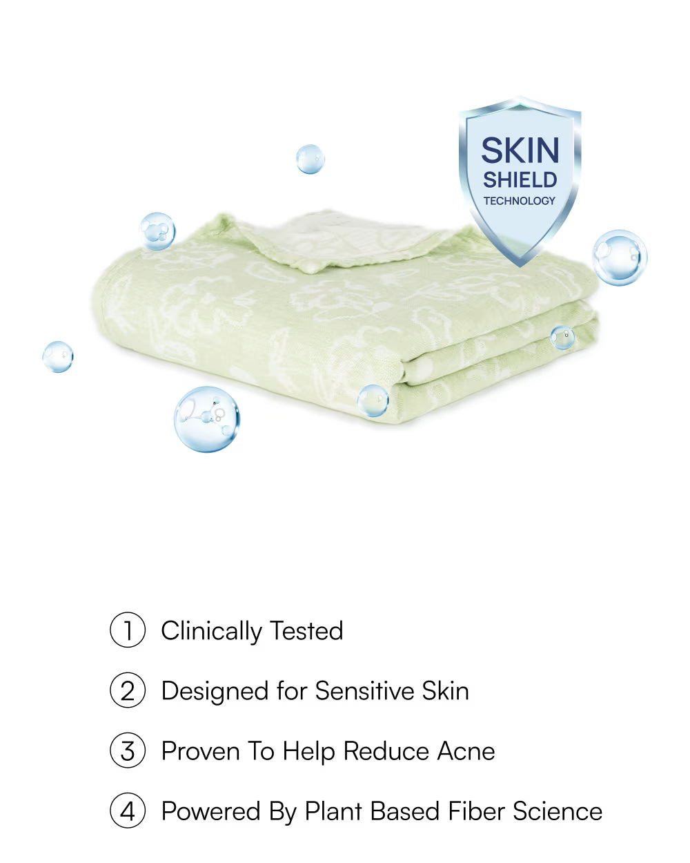 Folded green towels with 'Skin Shield' technology label on a white background