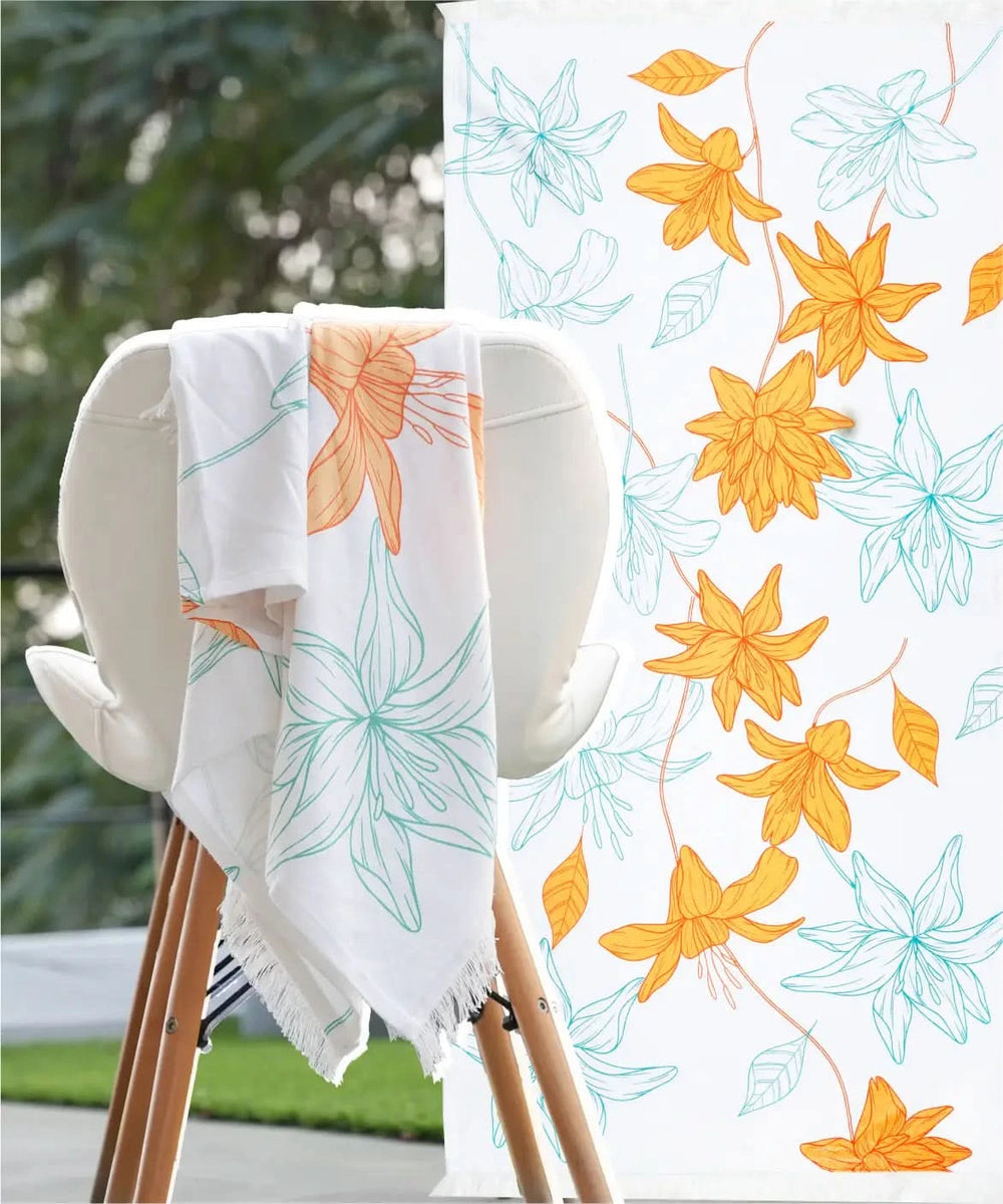Sunlit bloom patterned towel draped over a chair with a close-up of the floral design in the corner.