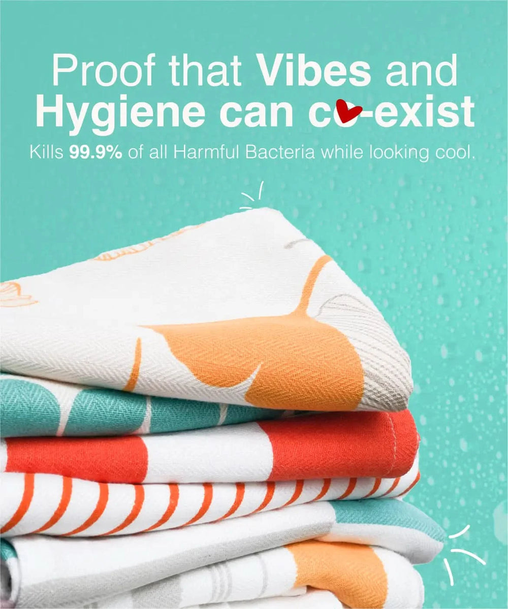 Stack of colorful towels with text about hygiene and bacteria-killing properties on a teal background