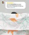Person holding a sunlit bloom towel with a review above it.