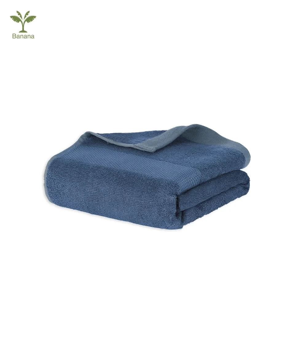 Folded blue banana super light terry towel on a white background. 