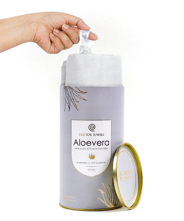 Hand opening a container of Doctor Towels Aloe vera towels on a white background