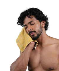 Man with a green towel on a white background