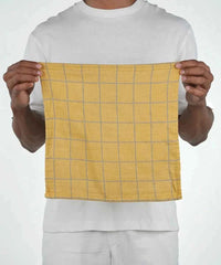 Person holding a yellow checkered towel against a white background