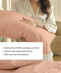 Person holding a honey peach pillow with Aloe vera plant properties text overlay