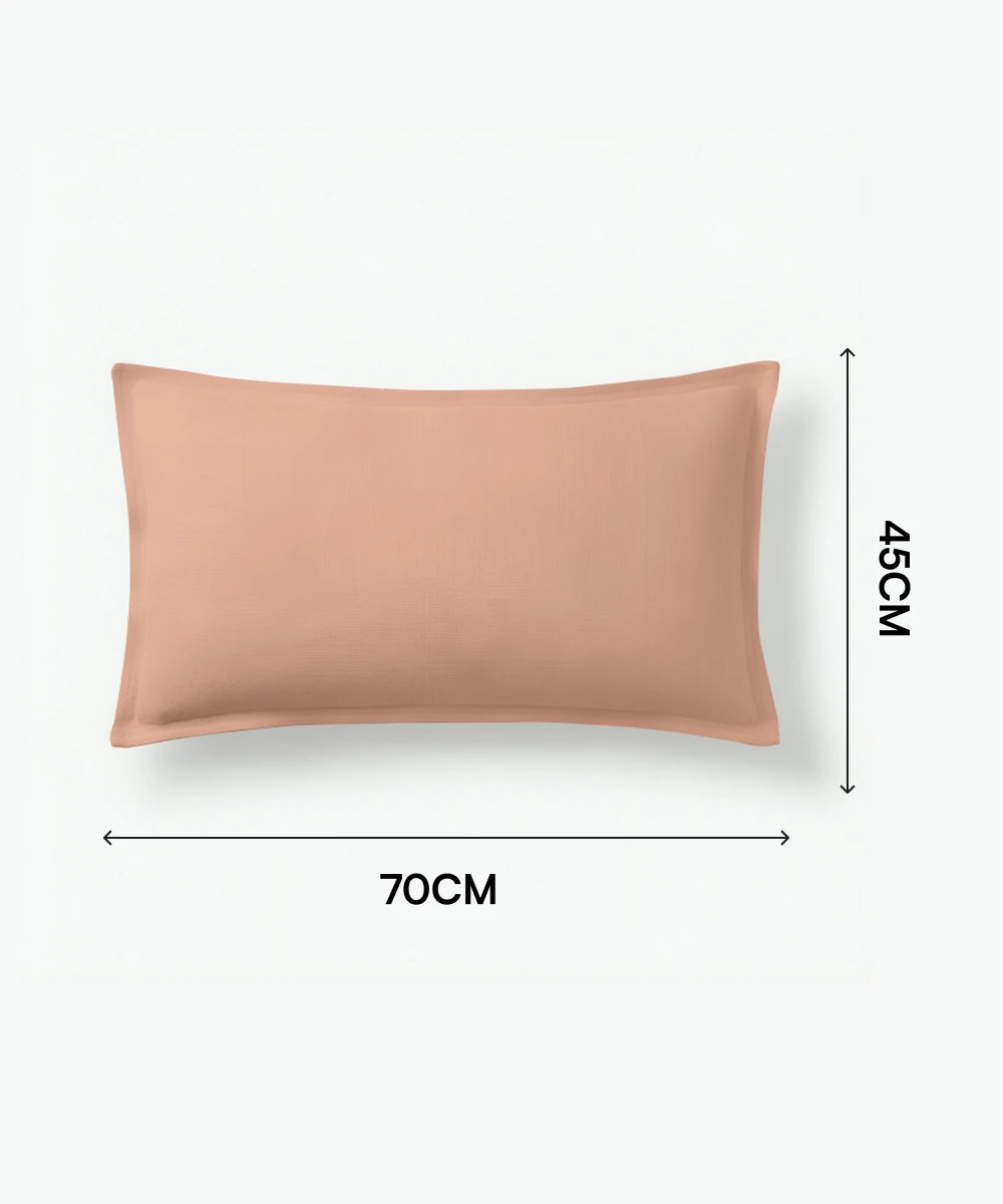 Peach-colored pillow with dimensions on a white background