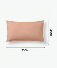 Peach-colored pillow with dimensions on a white background