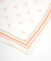 White napkin with pink floral pattern and border on a white background