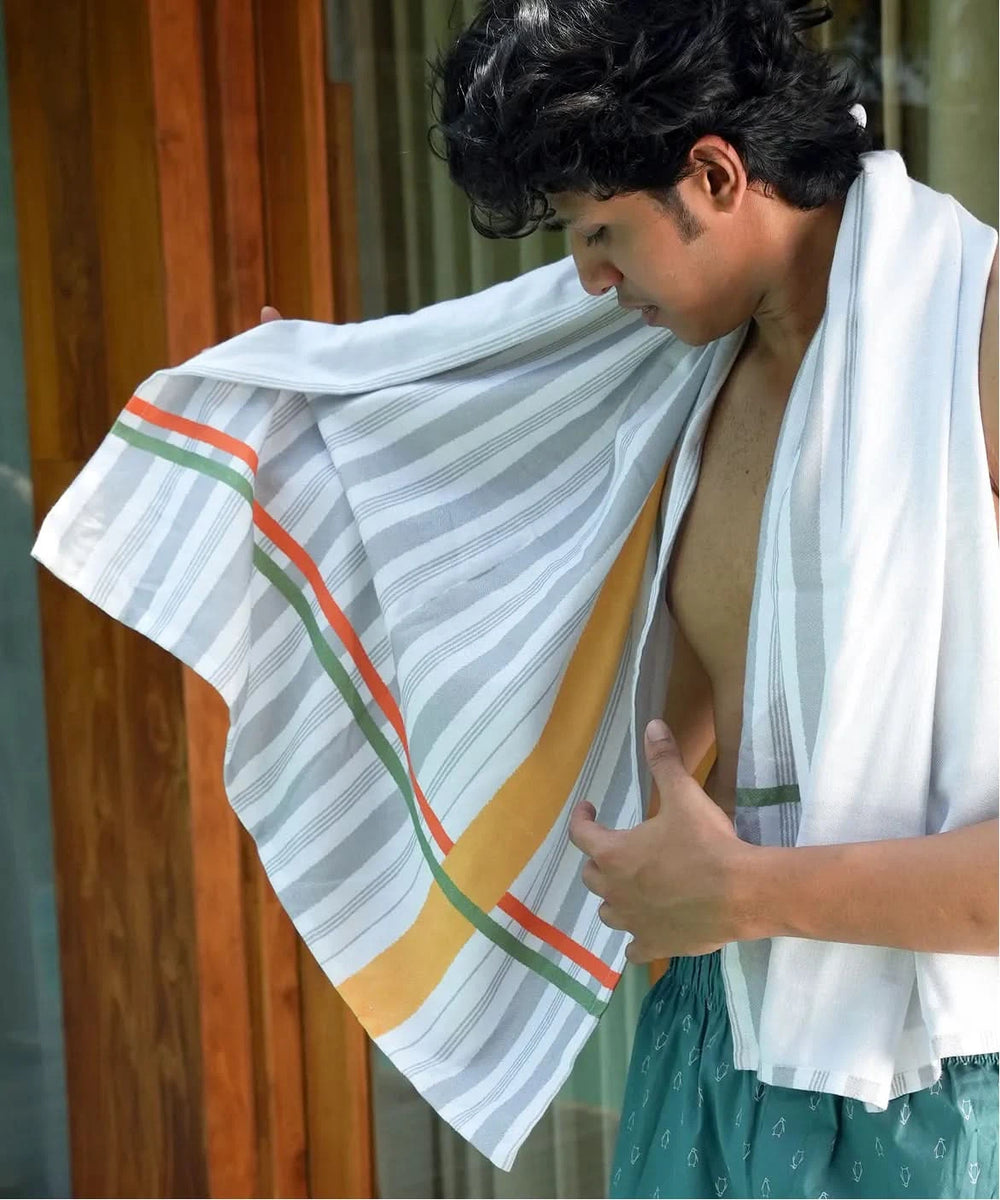 Person holding a just stripes in front of a wooden door.