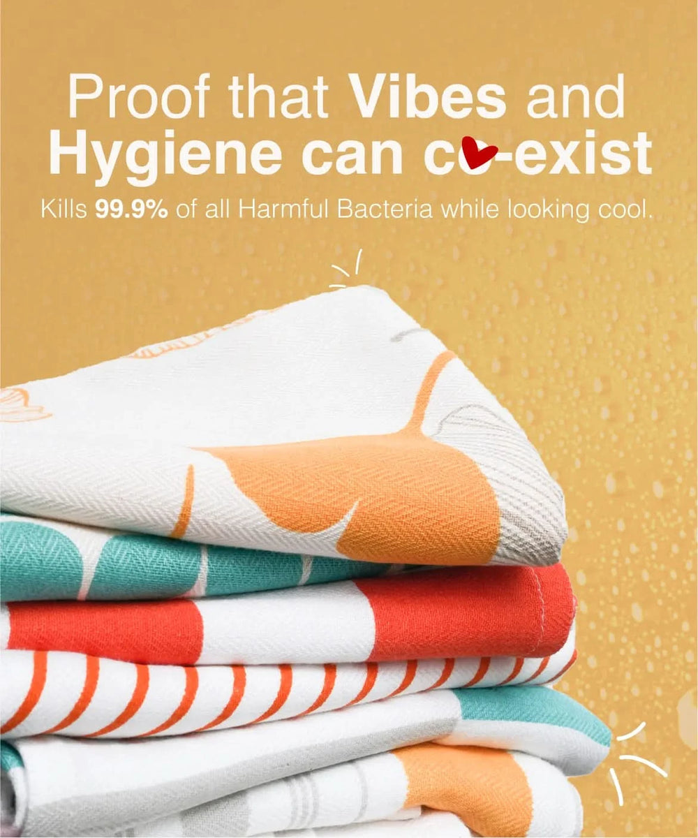 Stack of colorful towels with text about hygiene and bacteria killing on a beige background