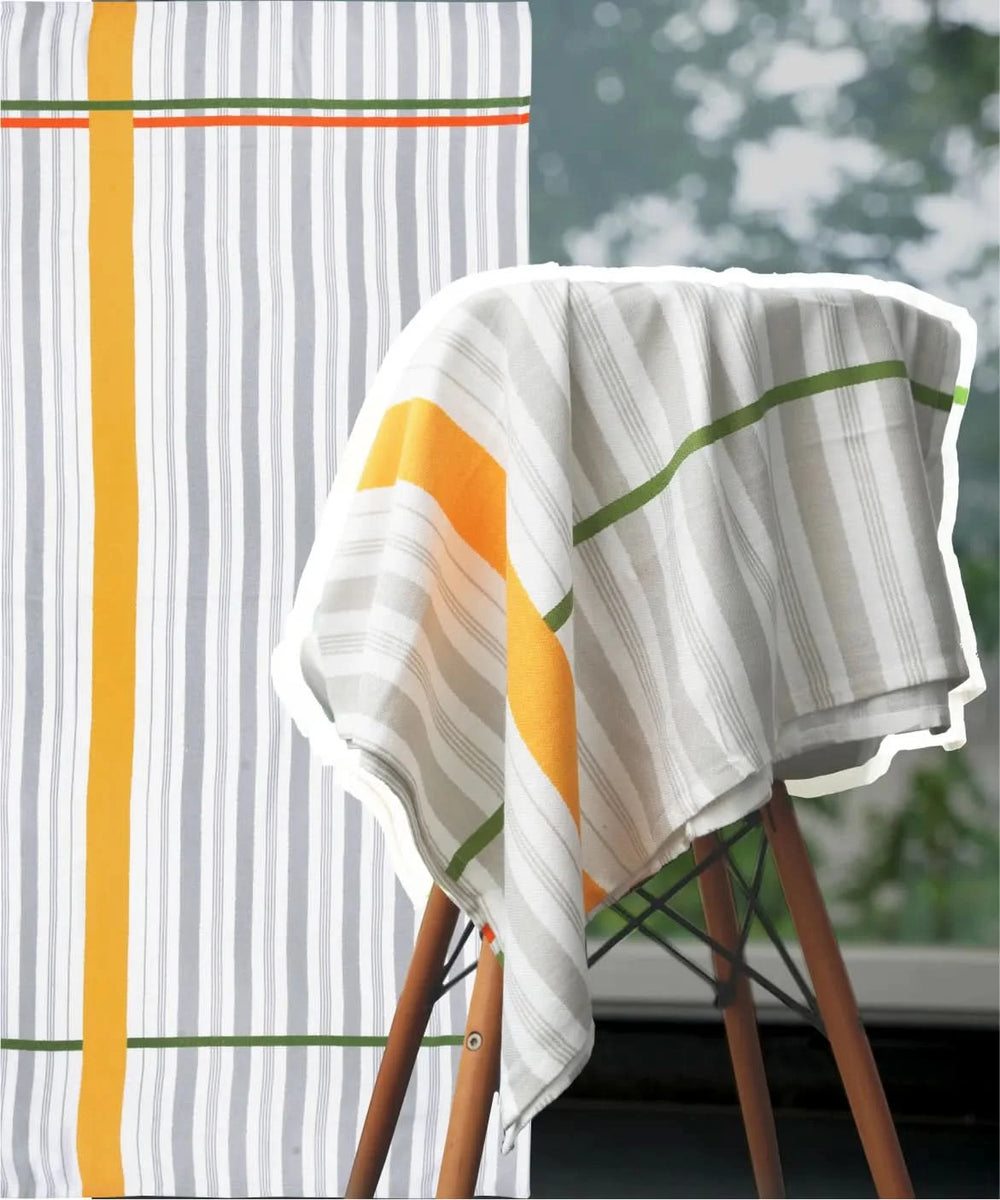 Just stripes bamboo bath towel, draped over a chair outdoors.