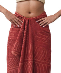 Red patterned towel wrapped around a person's waist on a white background