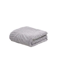 Folded gray textured blanket on a white background