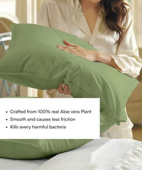 Person holding a aloe green pillow with Aloe vera plant properties text overlay