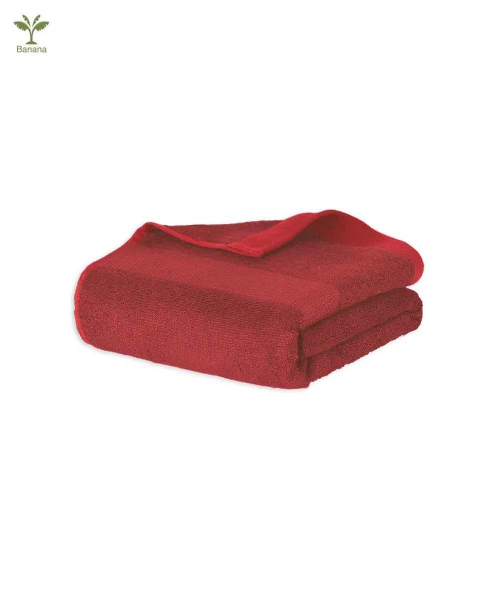 Folded scarlet red blanket on a white background