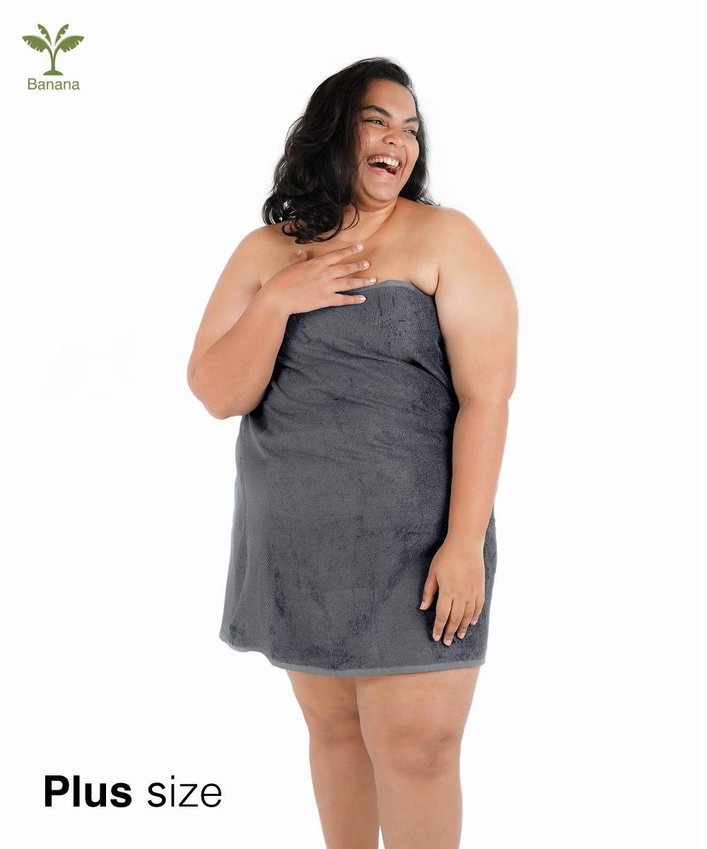 Woman wearing a shadow grey plus-size towel wrap on a white background