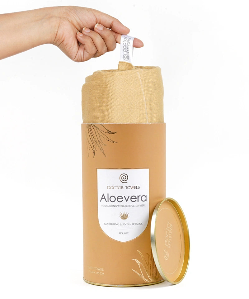 Aloe vera product with a hand pulling out a strip of a towel from a cylindrical container on a white background