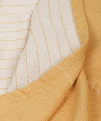 Close-up of yellow and white striped fabric of the towel