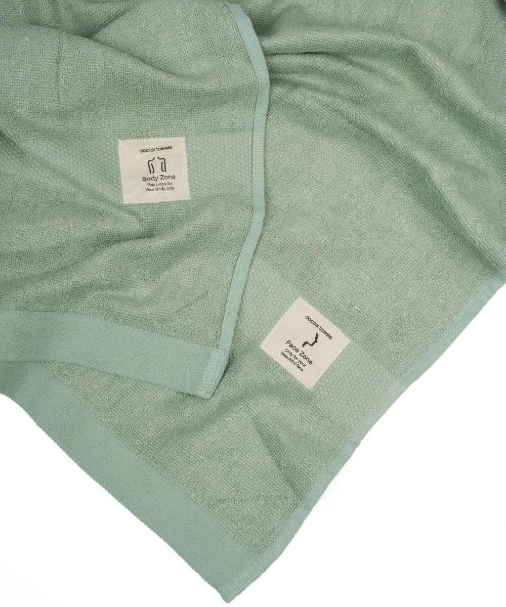 Green towel with brand label on a white background