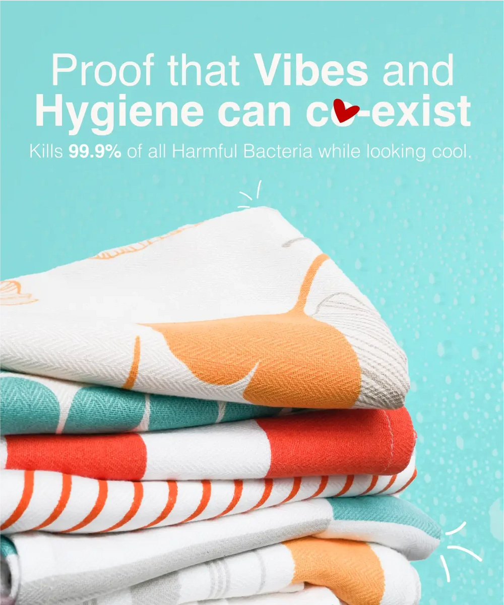 Stack of colorful towels with text about hygiene and bacteria-killing properties on a blue background
