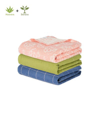 Stack of three folded towels in Red , green, and blue on a white background with Aloe vera and banana logos.