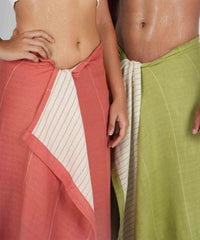 Two people wearing colorful towels, one red ( apricot brandy ) and one aloegreen, against a neutral background.